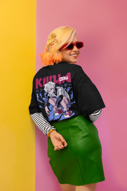 Person wearing a black jacket with a graphic design, striped shirt, and green skirt against a pink and yellow background.