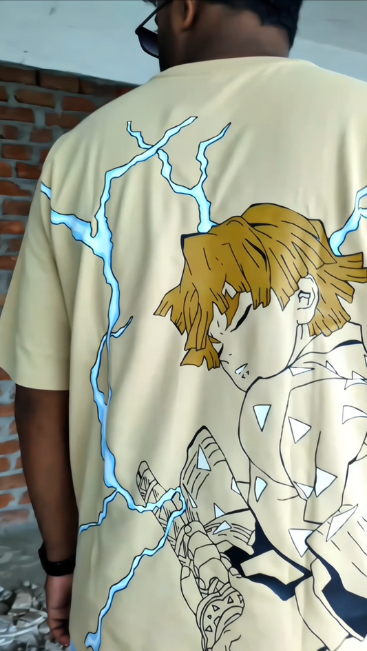 Person wearing a beige t-shirt with an anime-style design on the back.