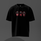 Black t-shirt with pink and red graphics on a dark gray background