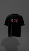 Black t-shirt with pink and red graphics on a dark gray background