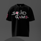 Black t-shirt with 'Squid Game' logo on a dark background